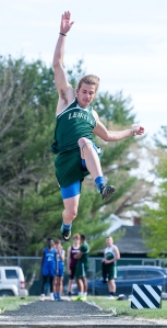 Lewiston's Billy Bedard flies to the air on his second jump that won the long jump during Tuesday's track meet at Gouin Field Complex in South Paris.
