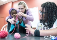 When Jashana Anderson,10, right, of Lewiston, first started to go to the Root Cellar after school about 4 years ago, she gravitated to the sewing, knitting and fabric art program. Thursday afternoon, she was helping volunteer Sarah Minnich, left, of Durham, help Zahra Abo, center, 8, learn how to crochet. The mission statement of the Root Cellar is" The Root Cellar is a Christian Mission with the goal of uniting the local community in the common cause of satisfying the physical and spiritual needs of inner-city youth and their families.
