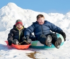 Elliott Hill, 8 and Bjorn Sandberg, 8, both of Auburn and students at Sherwood Heights Elementary School , scream as they fly down the hill next to the Auburn school Saturday afternoon. They have been waiting all vacation to go sledding, and with the cold weather hardening the recent snow, the conditions were finally perfect.